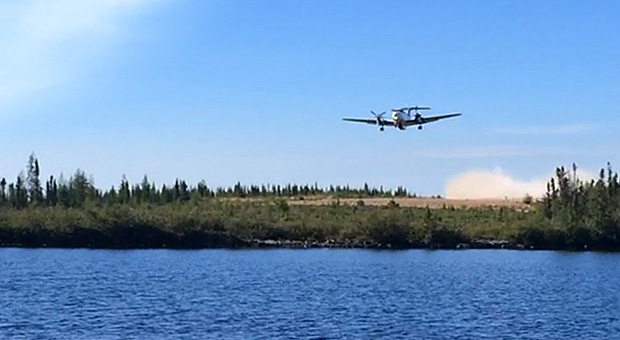 Plane taking off from Misaw Lake Lodge runway